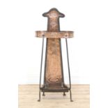 An Arts and Crafts copper and wrought iron umbrella stand,