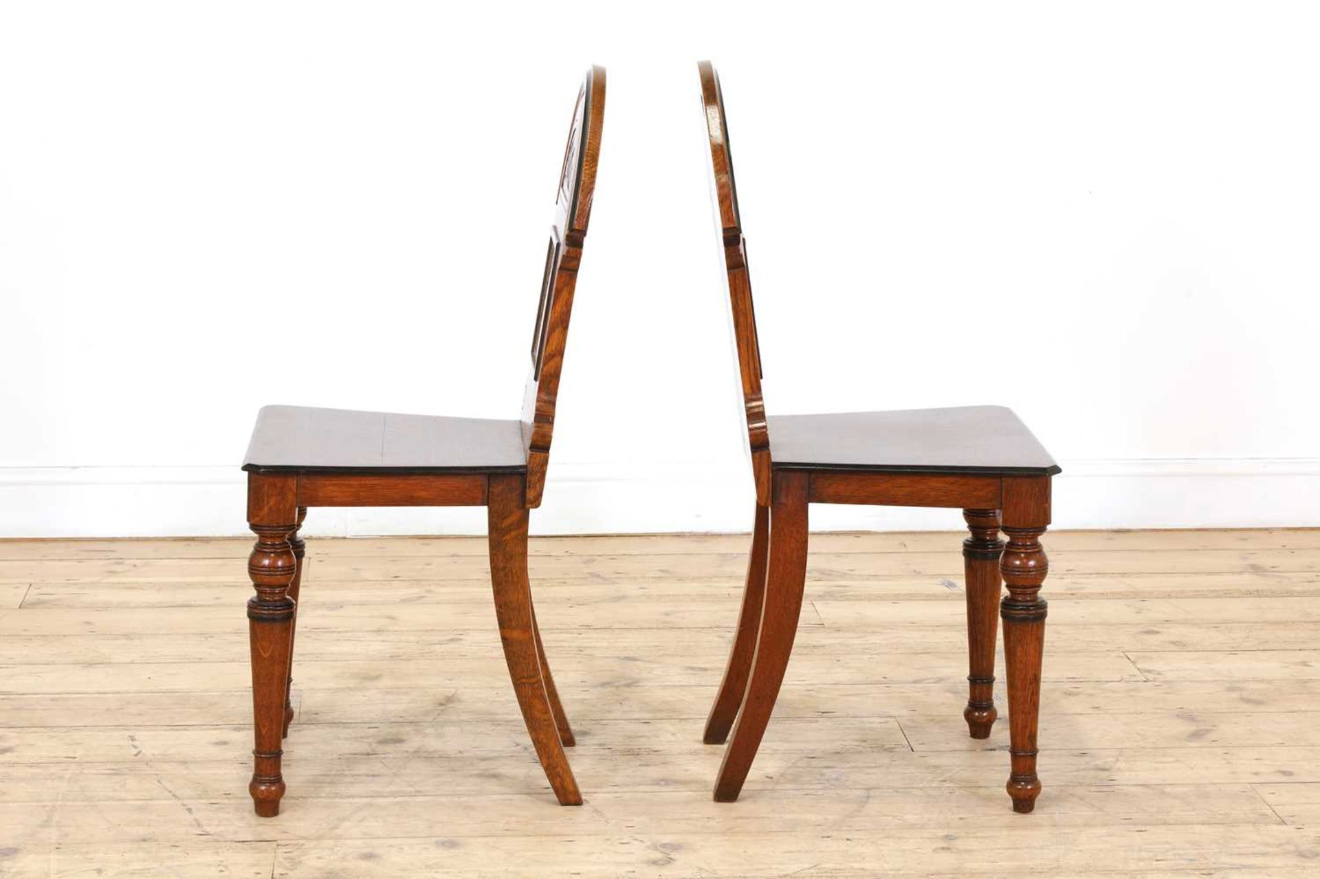 A pair of Aesthetic Movement oak and ebonised hall chairs, - Image 4 of 5