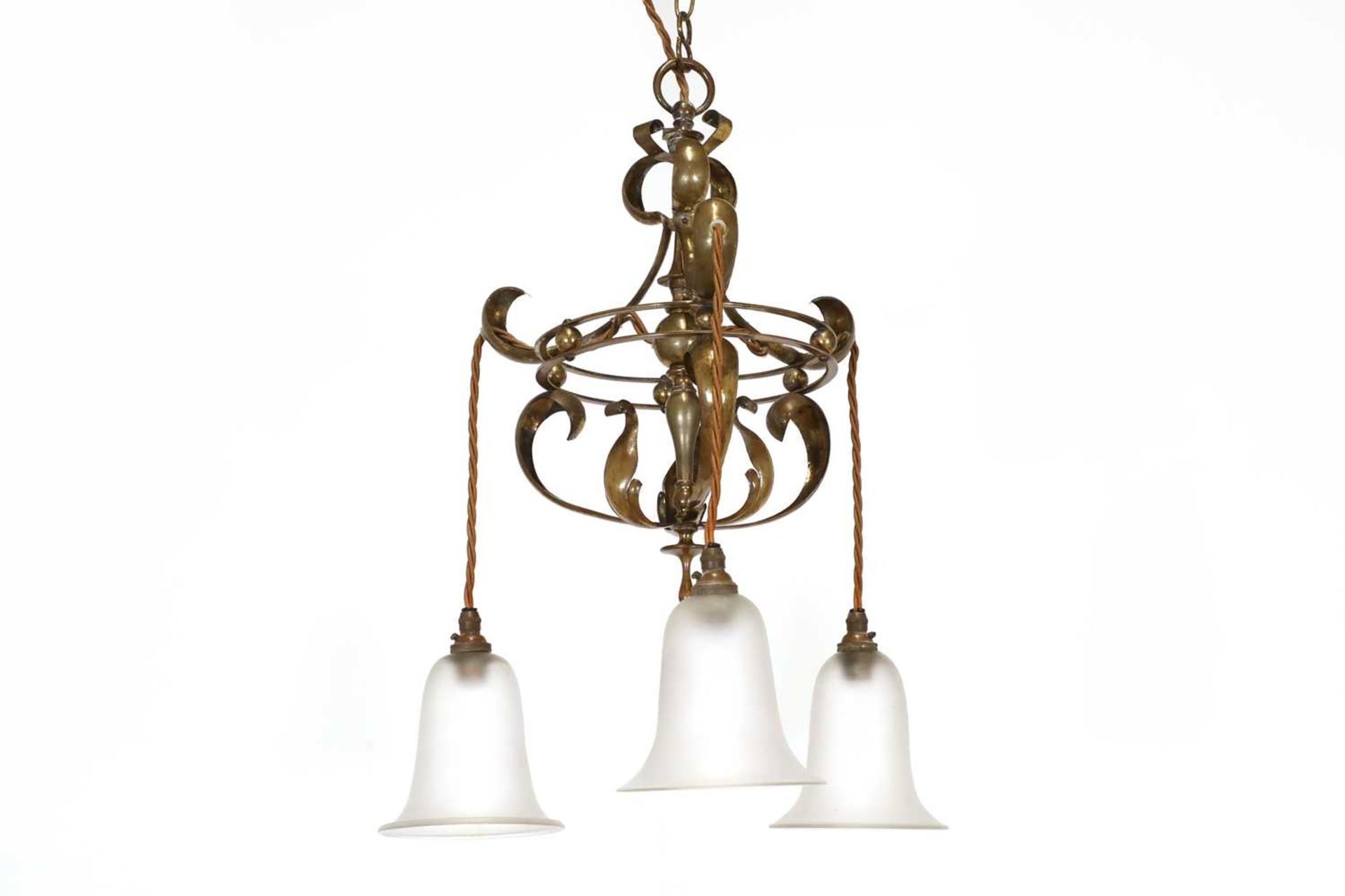 An Arts and Crafts brass three-branch hanging ceiling light,
