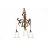 An Arts and Crafts brass three-branch hanging ceiling light,