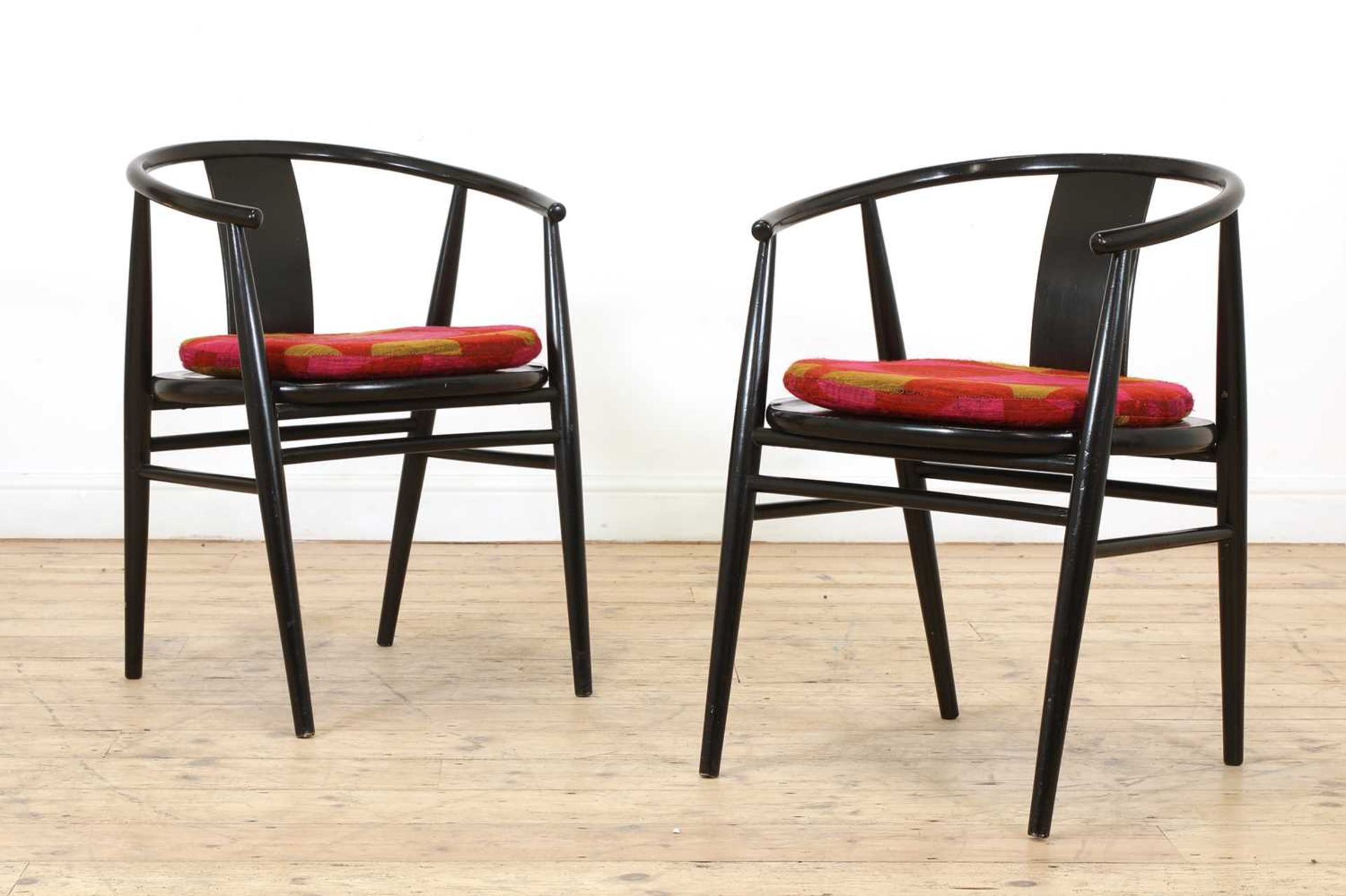 A pair of Scandinavian ebonised armchairs,