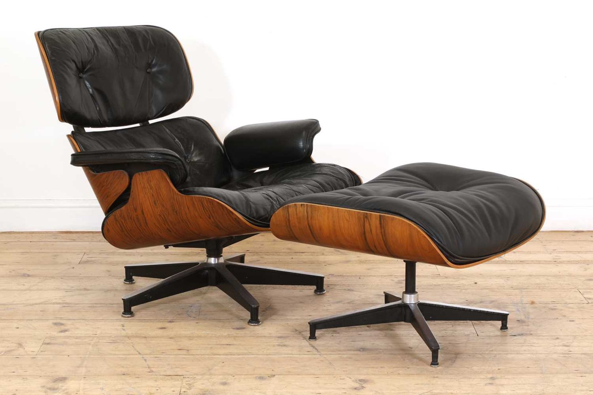An Eames 'Model 670' and 'Model 671' rosewood lounge chair and ottoman,