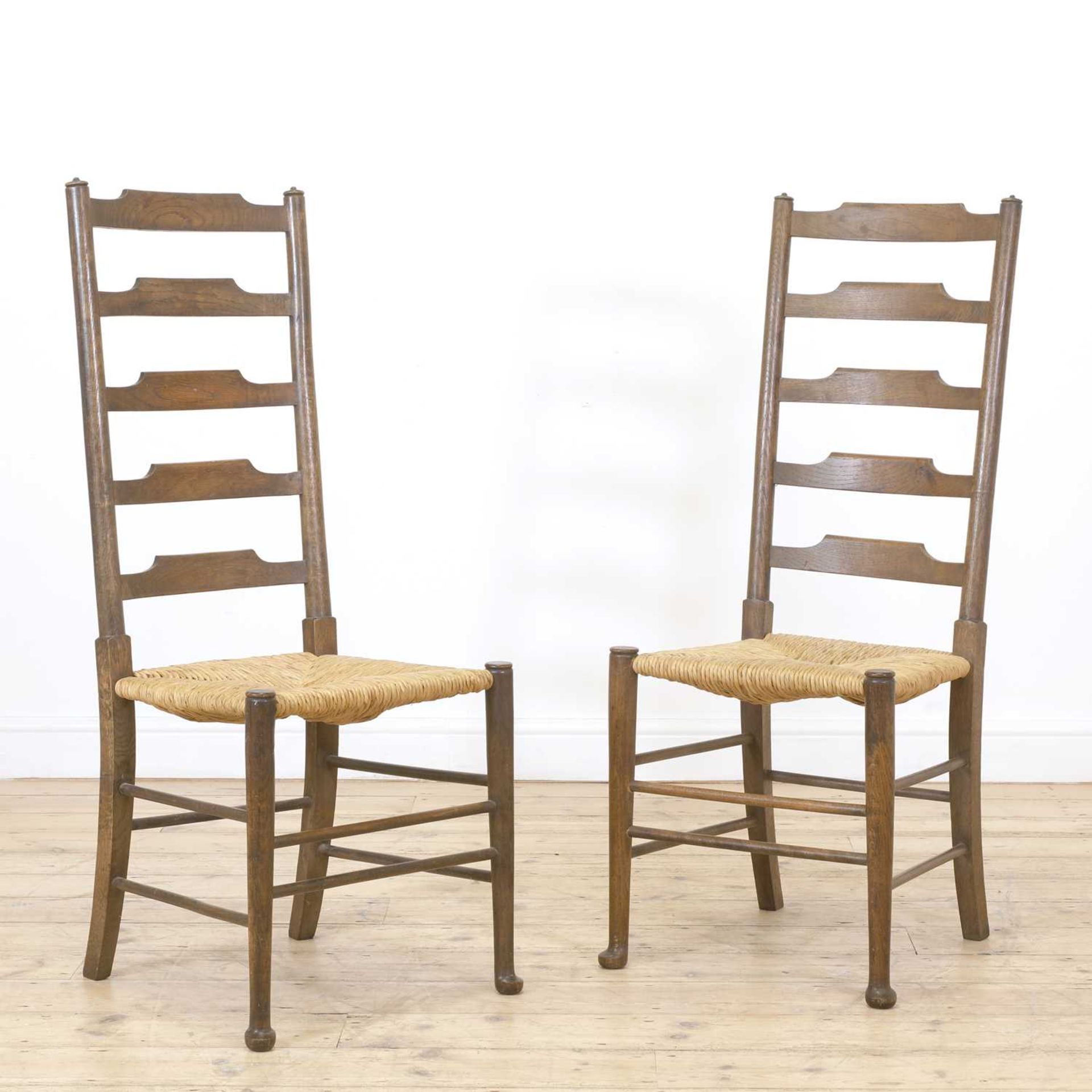 A pair of Arts and Crafts oak side chairs,