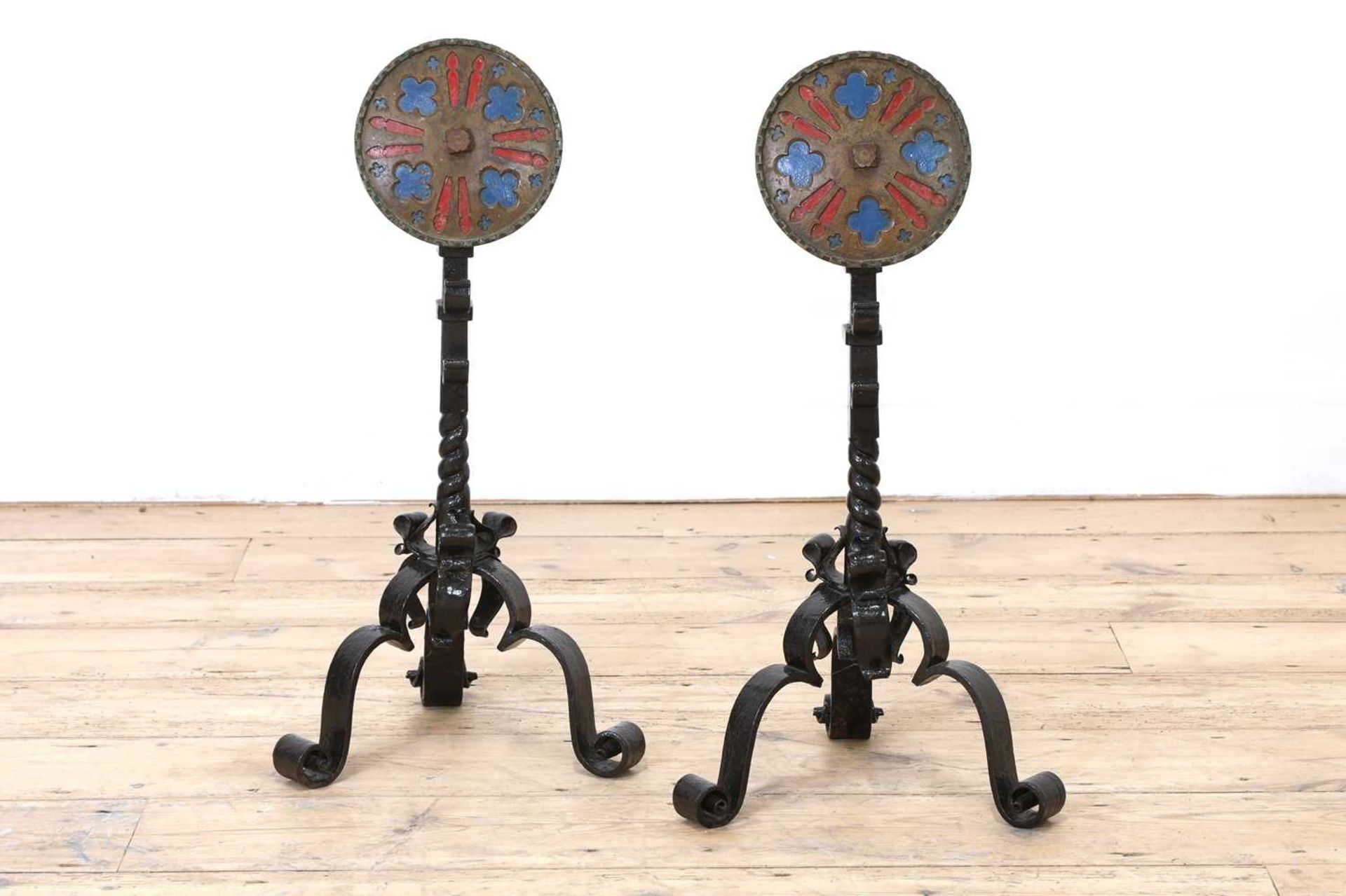 A pair of wrought iron firedogs,