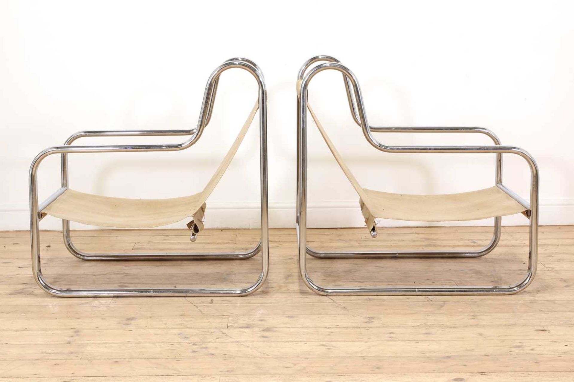 A pair of chrome lounge chairs,