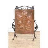 An Arts and Crafts copper embossed fire screen,