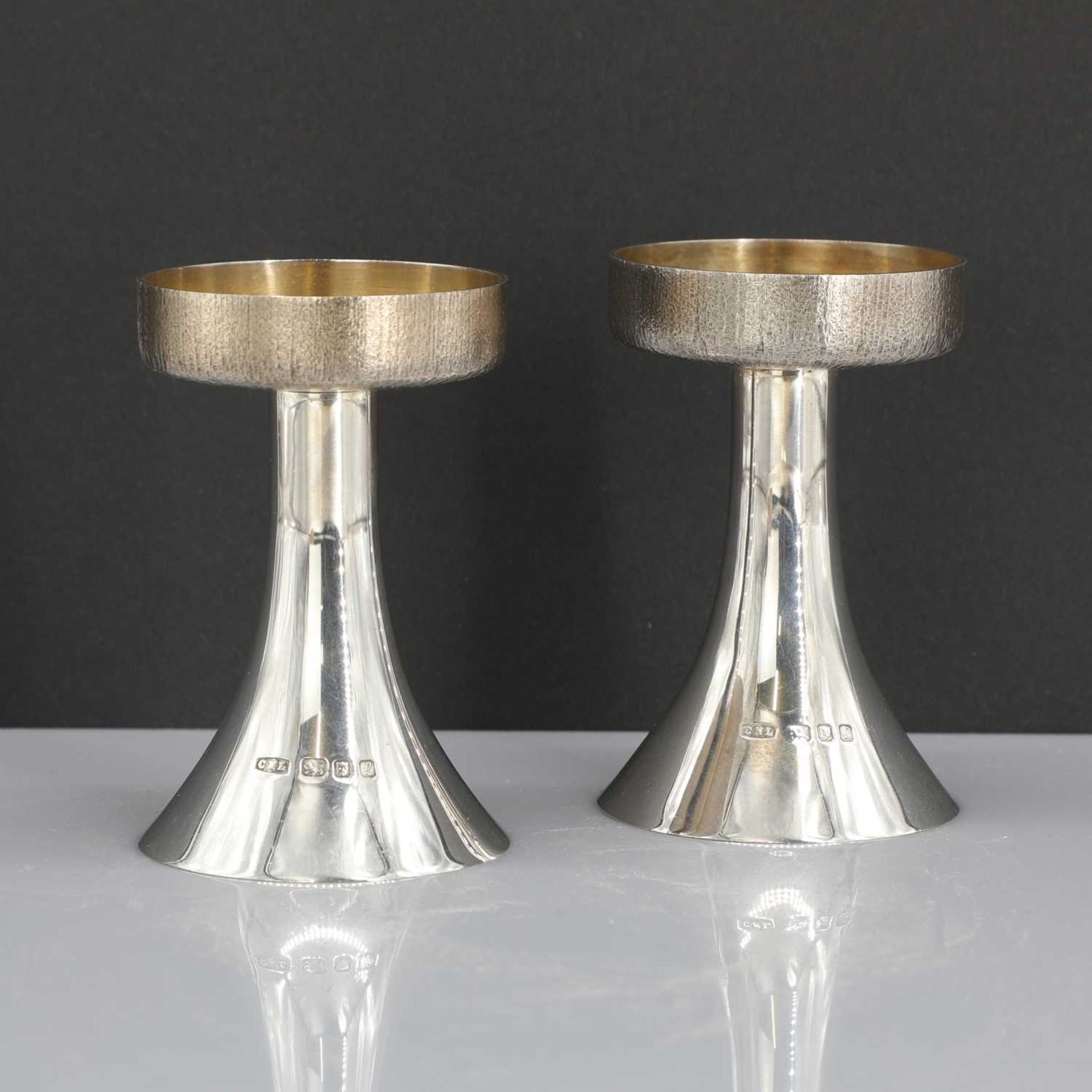 A pair of silver candlesticks,