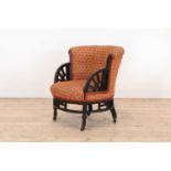 An ebonised armchair,