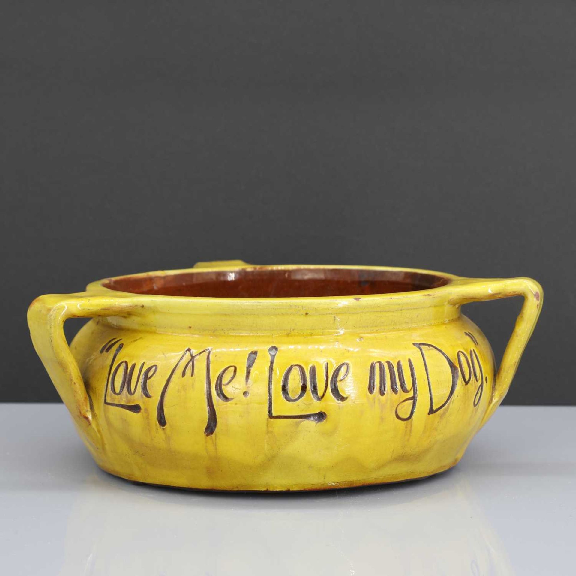 A rare Liberty & Co. yellow pottery dog bowl,