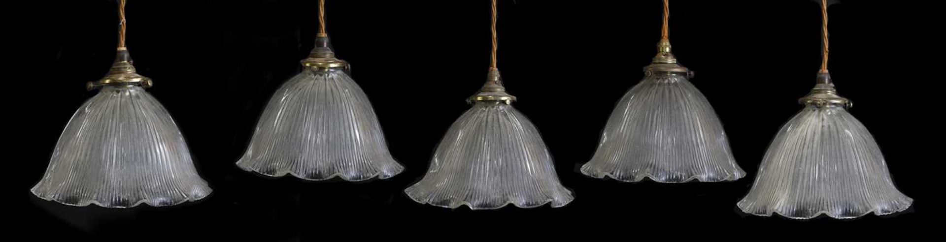 Five moulded glass Holophane ceiling lights,