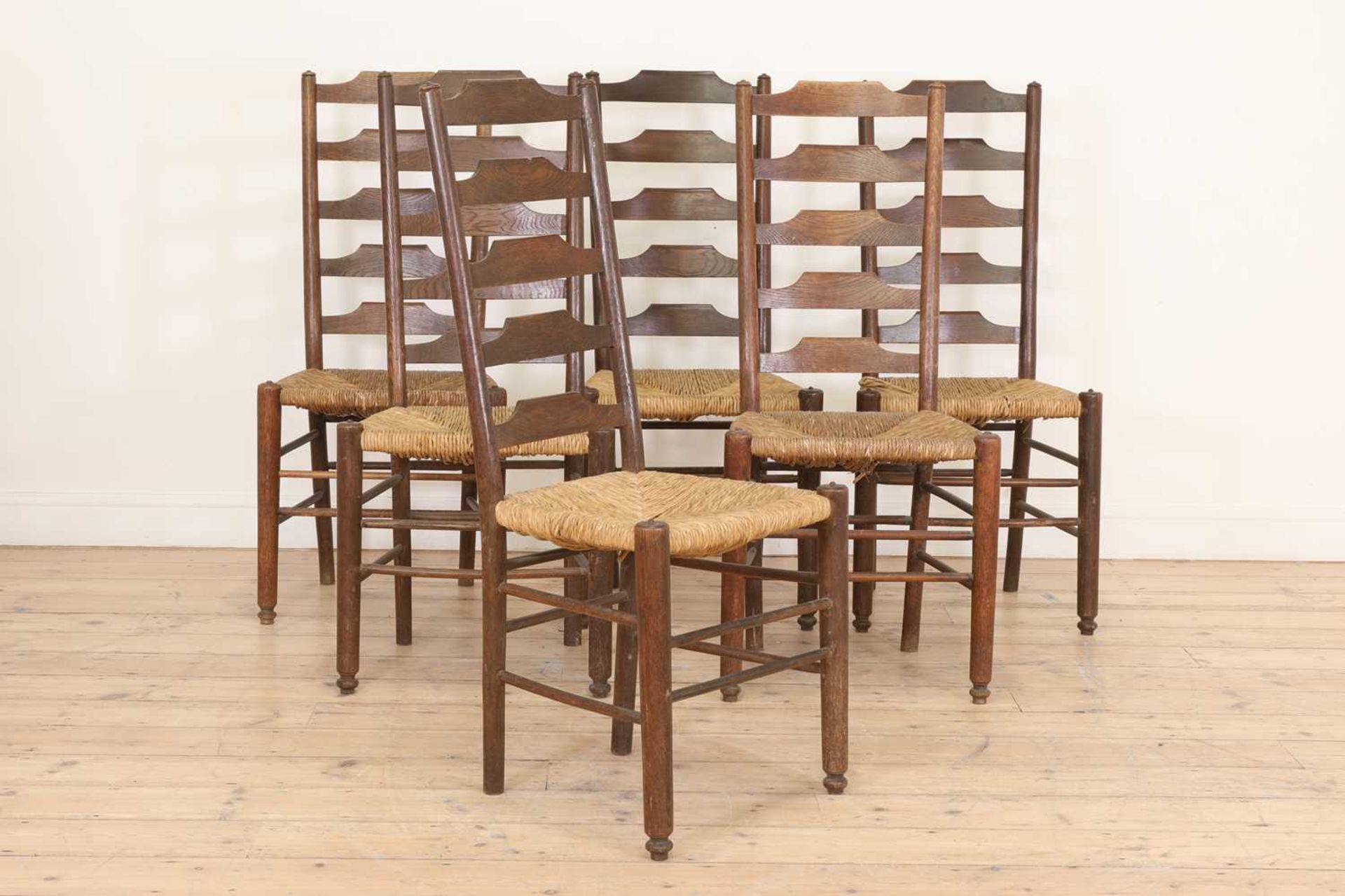 A set of six Heal's oak ladder-back chairs,