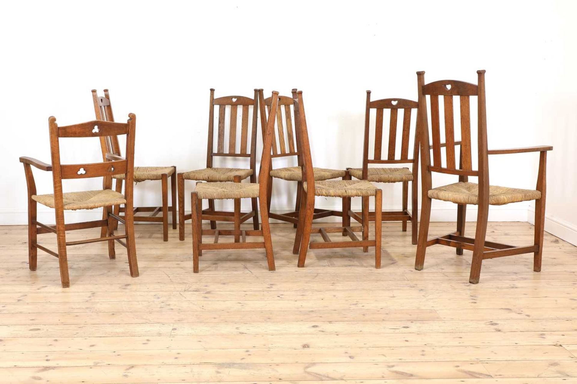 A set of six rush seat chairs and an armchair