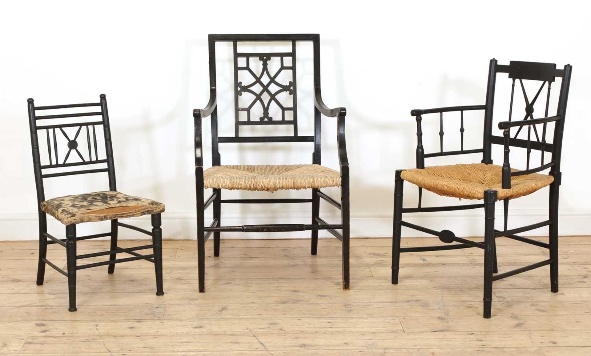 Two ebonised armchairs and a child's chair,