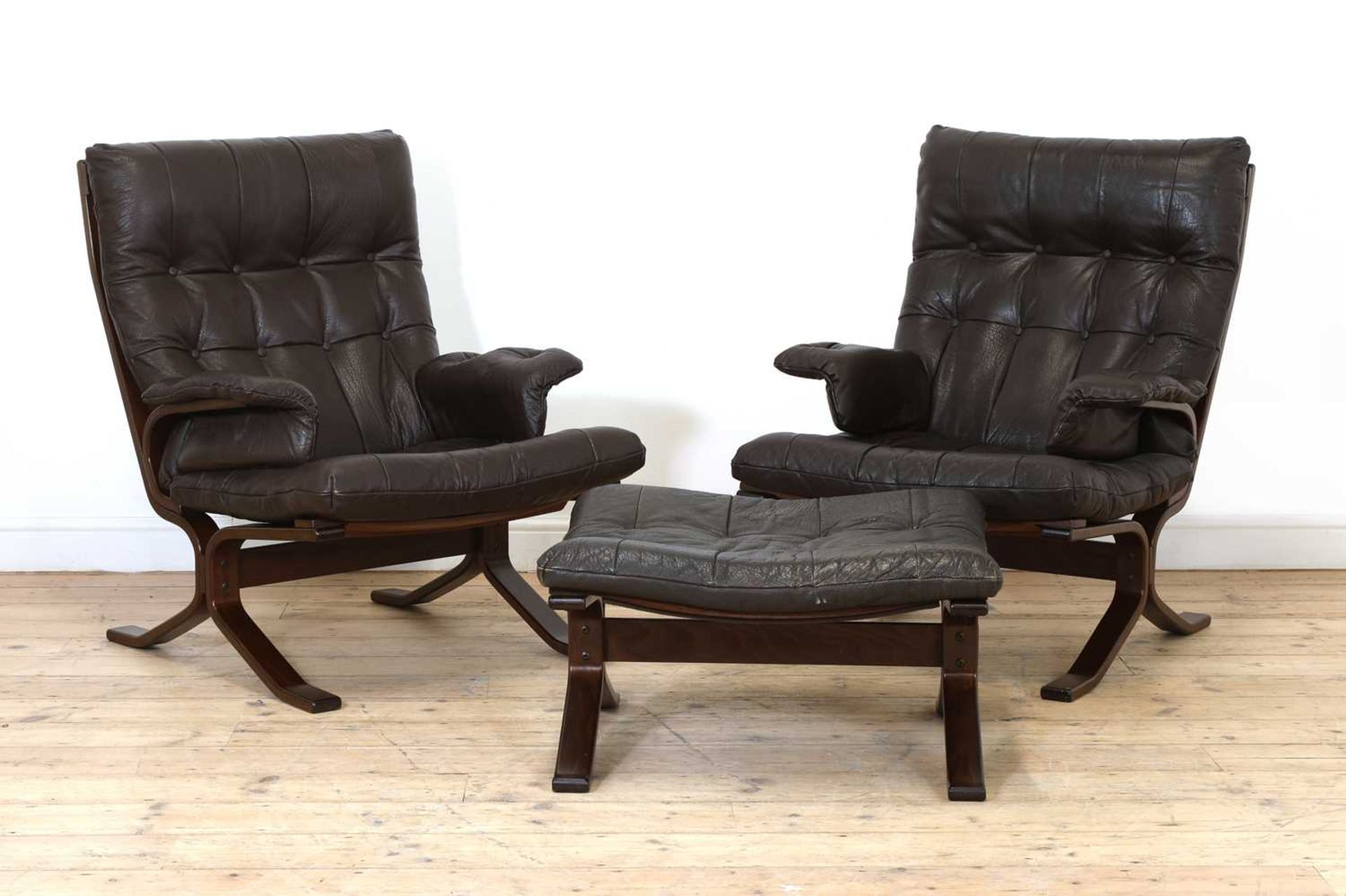 A pair of Westnofa leather and bentwood loungers,