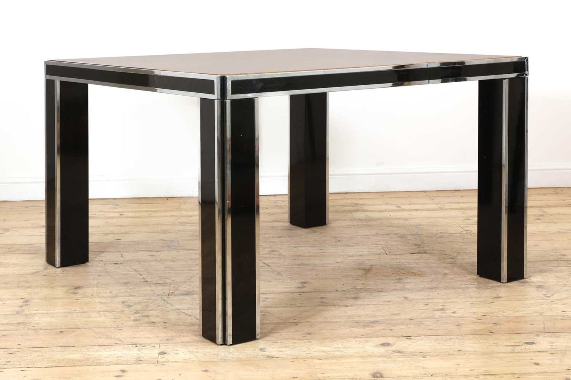 An olivewood and brass dining table,