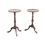 A near pair of mahogany inlaid tripod tables or stands