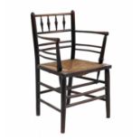 An Arts & Crafts ebonised Sussex chair