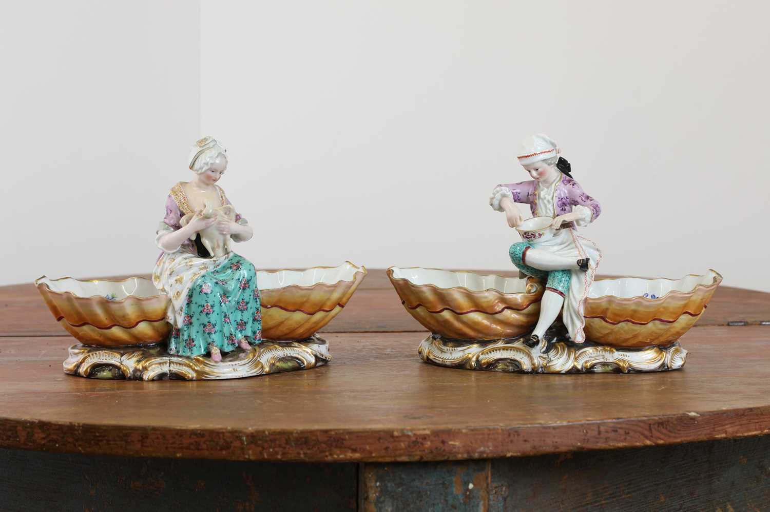 A pair of Meissen porcelain figural double salts,