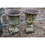 A pair of cast iron campana garden urns,
