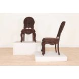 A pair of carved teak chairs,
