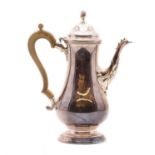 A large silver coffee pot