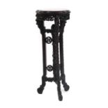 A carved hardwood jardiniere stand,