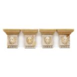 A set of four grey painted wood architectural mounts,
