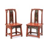 A near pair of red lacquer low chairs,