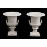 A pair of cast iron two handled Campagna urns,