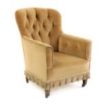 An Edwardian buttoned tub chair,