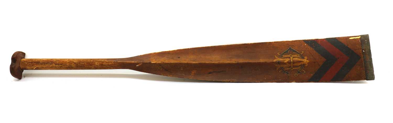 A carved and painted wood rowing oar,