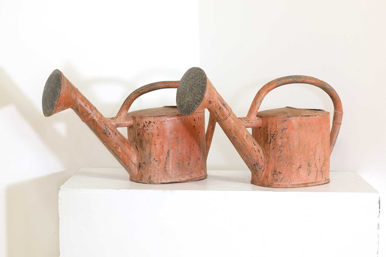 A pair of toleware watering cans,