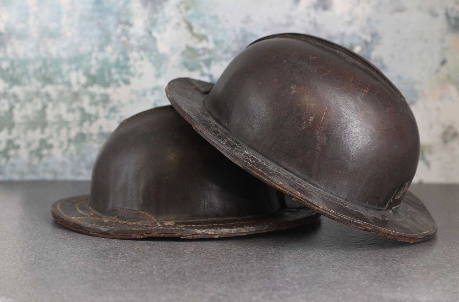 A pair of patinated leather miner's helmets, - Image 2 of 5