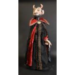 A carved and painted wooden hand puppet of the Devil,