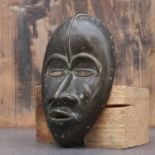 Dan society: a cast bronze mask,