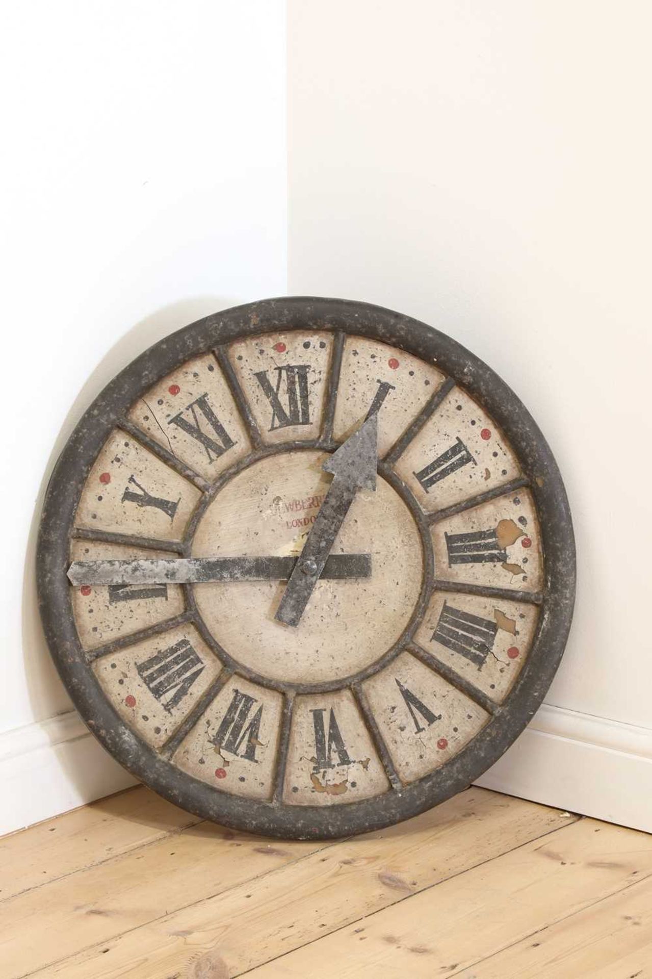 A painted wooden clock face,