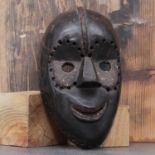 Dan society: a carved and patinated mask,