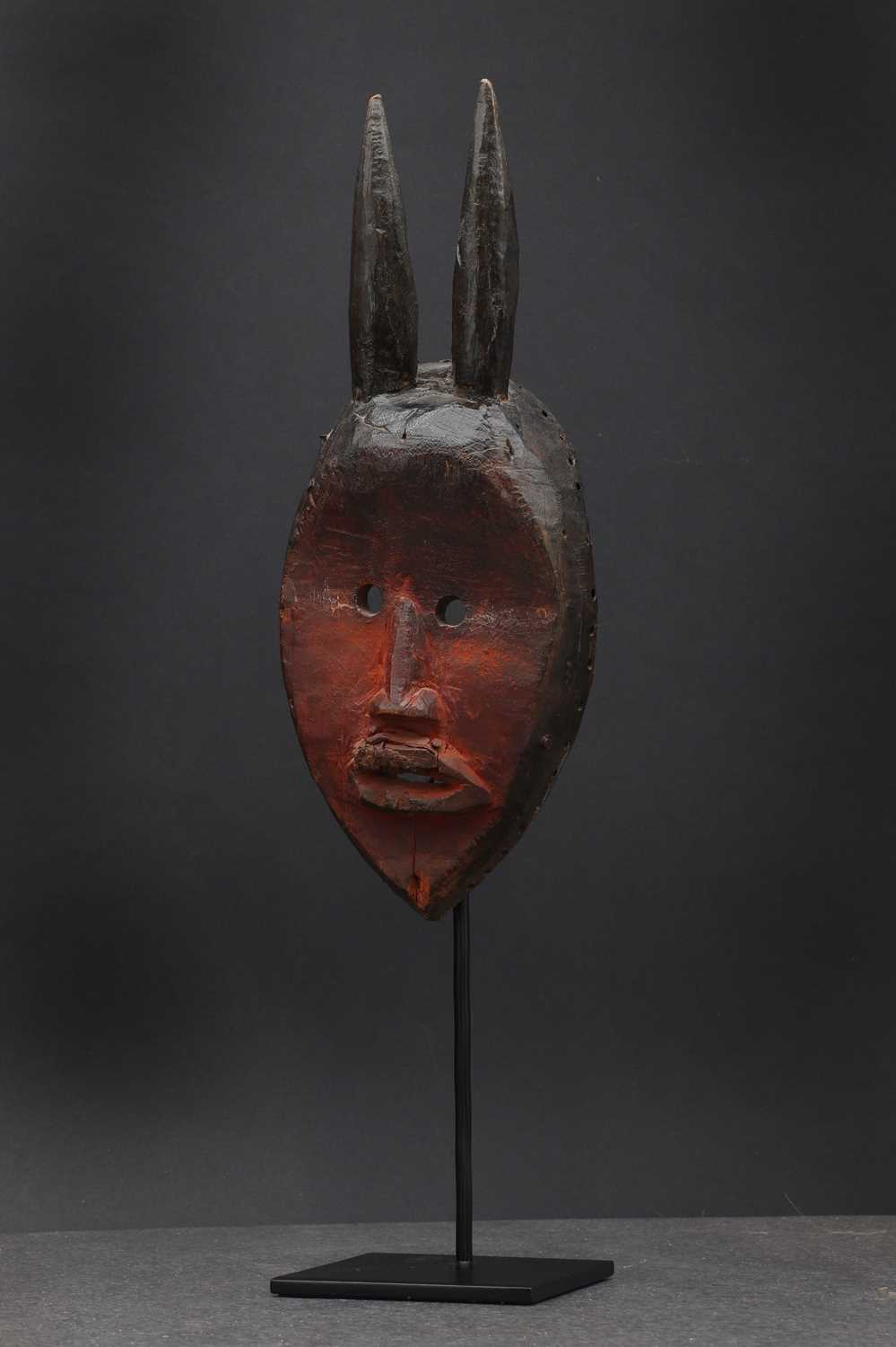 Dan society: a carved and patinated Dan mask,