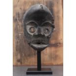 Dan society: a carved and patinated Dan mask,