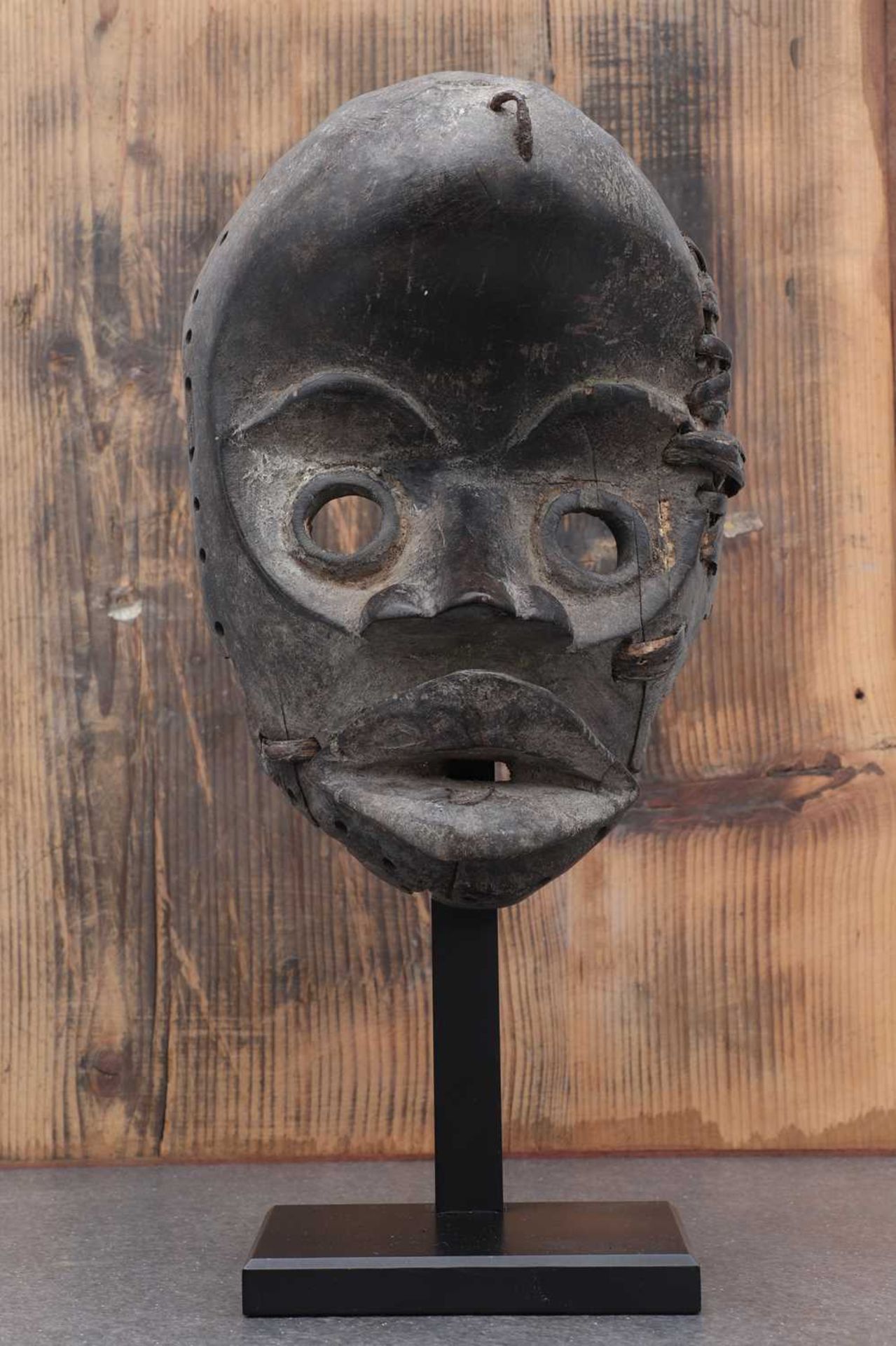 Dan society: a carved and patinated Dan mask,
