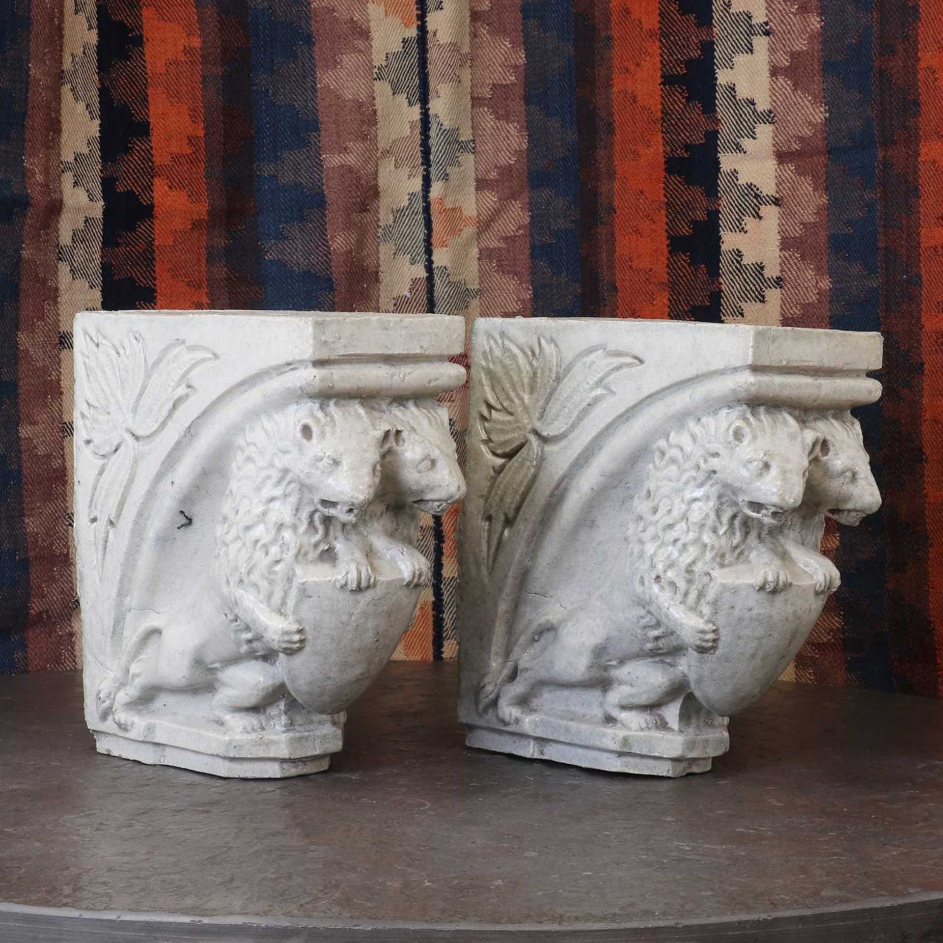 A pair of glazed stoneware corbels,