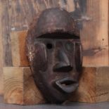 Dan society: a carved and patinated Kagle mask,