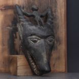 Dan society: a carved and patinated anthropomorphic mask,