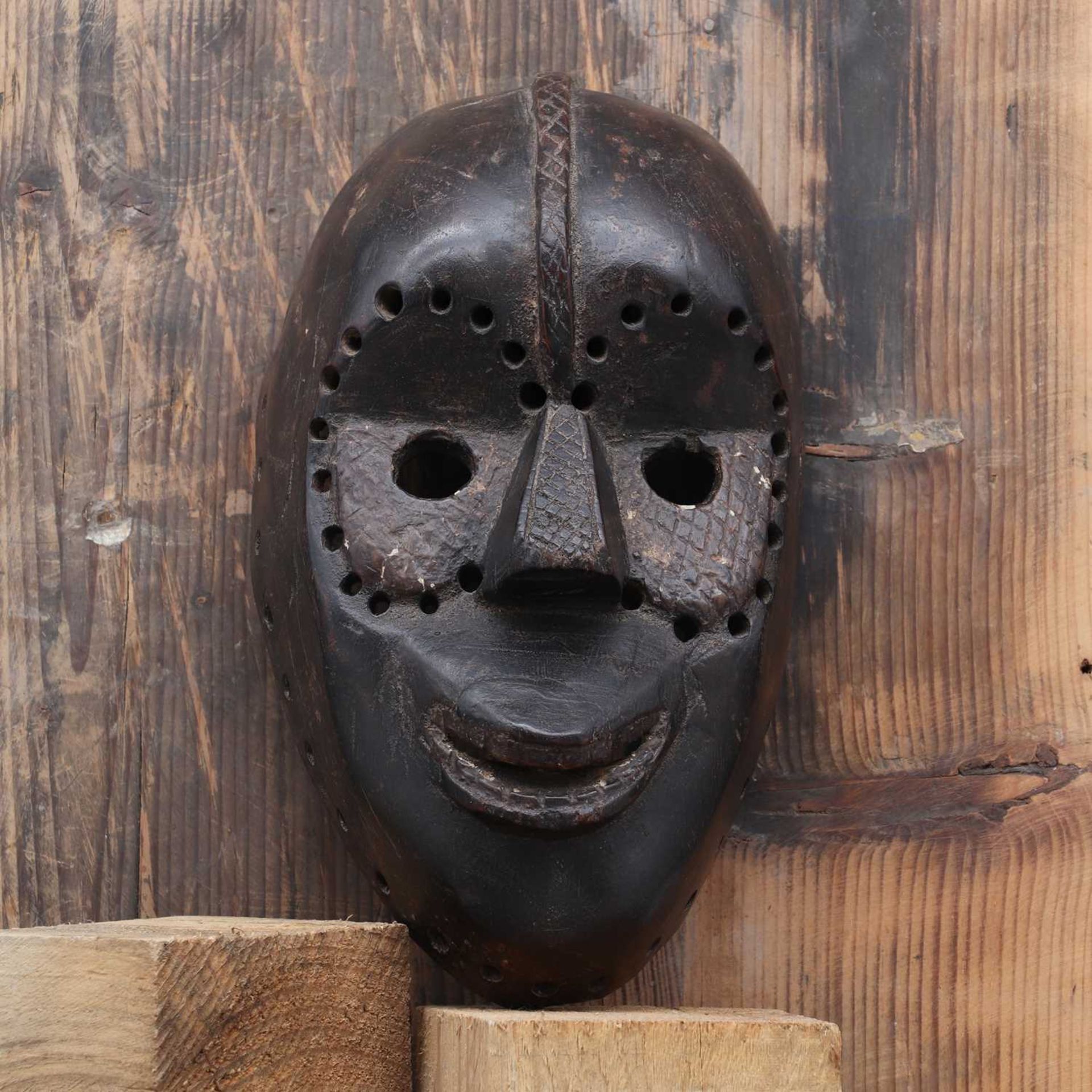 Dan society: a carved and patinated mask, - Image 2 of 3