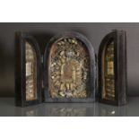 A Continental ebonised triptych reliquary,