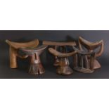 A collection of six carved Bari headrests,