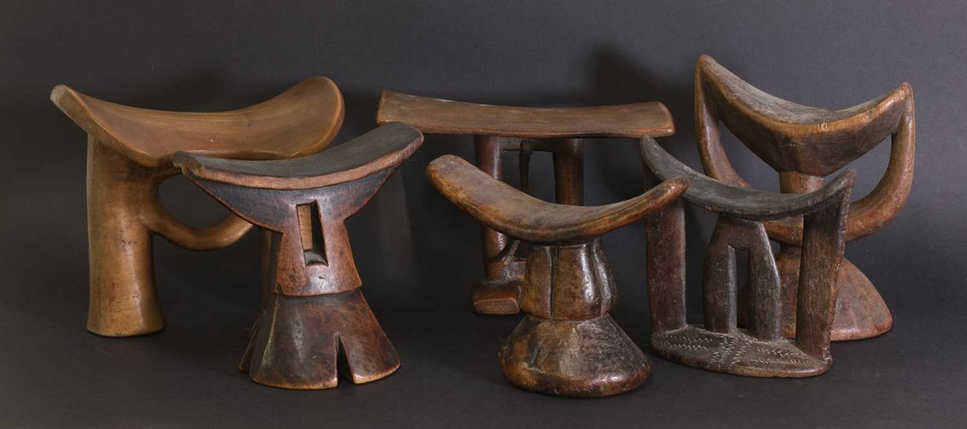 A collection of six carved Bari headrests,