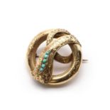 A gold and turquoise snake brooch,