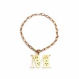 A gold bracelet with initial charm 'M',