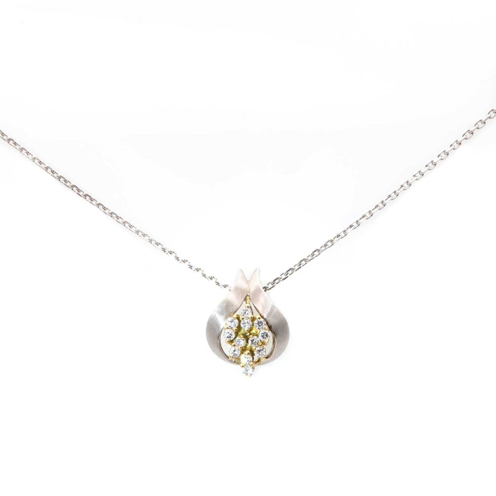 An 18ct yellow and white gold diamond set cluster pendant,